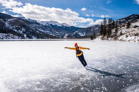 Female Wild Ice Skater on A Frozen Lake in Colorado