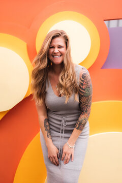 Smiling Blonde  tattoo  woman with colorful background