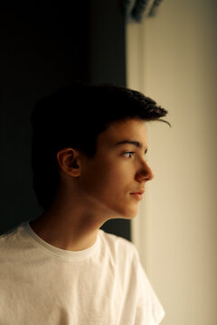 Portrait of teenager looking trough the window