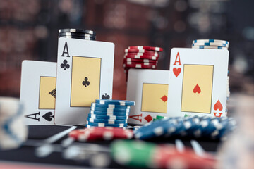 Poker playing four aces  with stack of chips on the casino table