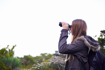 Woman, binoculars and hiking view on mountain on misty morning or nature explore, trekking or...