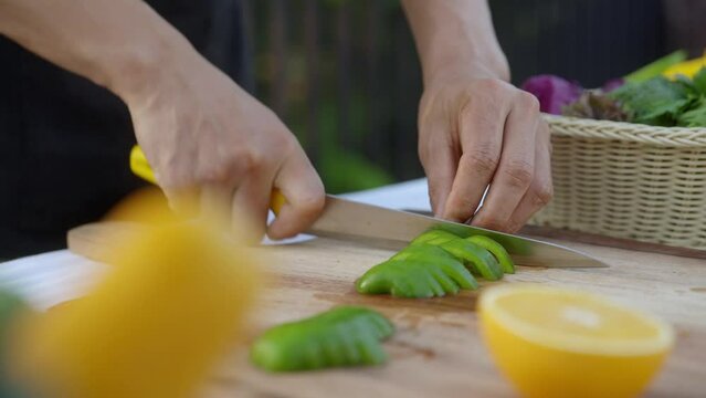 Chopping Green Capsicum on a Wooden Cutting Board - Close Up Slow Motion




