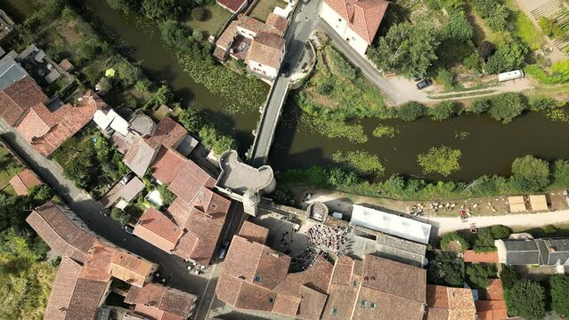 Overhead Aerial View with Vortex of River Flowing Through Medieval Town