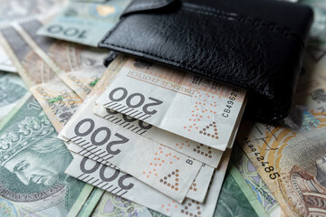 100 200 Polish zloty PLN banknote in black wallet