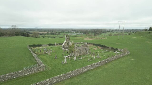 Old Graveyard And Church Near Carbury Castle in County Kildare, Ireland. - aerial shot
