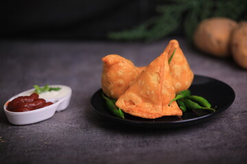 Samosa Indian famous street food snack closeup with selective focus and blur