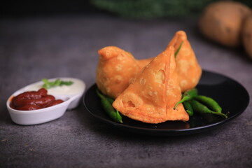 Samosa Indian famous street food snack closeup with selective focus and blur