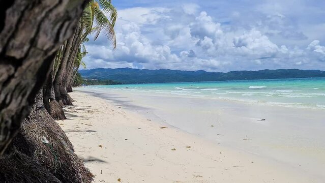 Tropical Boracay Island and White Beach, Philippines, Revealing Shot Behind Palm Tree