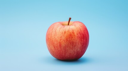 one red apple isolated on a blue background