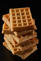 Belgian waffles isolated on black background