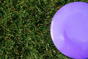 leisure games, toys and sport concept - close up of flying disc on grass - 767711264