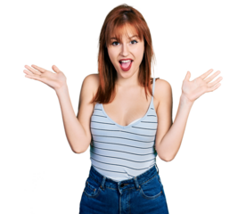 Redhead young woman wearing casual style with sleeveless shirt celebrating victory with happy smile and winner expression with raised hands