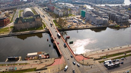 Drone shot captures March day in Szczecin, Poland, showing Long Bridge with passing cars. © Grzegorz