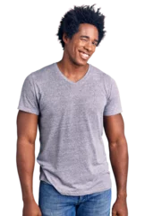 Fotobehang Handsome african american man with afro hair wearing casual clothes winking looking at the camera with sexy expression, cheerful and happy face. © Krakenimages.com
