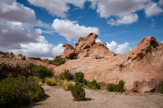 Desert Rock Formation in Orange Sand, Cloud Sky Stock Photo - Rural Bolivia 