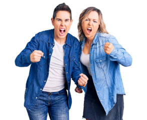 Couple of women wearing casual clothes angry and mad raising fists frustrated and furious while shouting with anger. rage and aggressive concept.