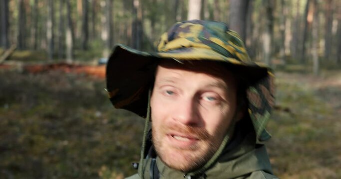 content creator vlogger walking in forest and recording video, talking to camera. vlogging