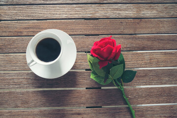 Tabletop black coffee cup red rose on wood table background with empty copy space. Espresso shot...