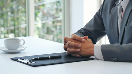 Businessman hands note meeting document in conference room. man Hands writing planning notebook. Close up male hand holding pencil write on diary sketchbook at office desk. Business Planning Concept