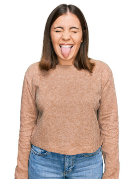 Young beautiful woman wearing casual clothes sticking tongue out happy with funny expression. emotion concept.