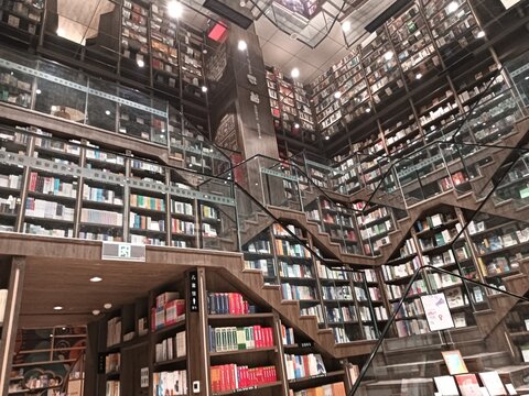 Chongqing city, China - March 05, 2024. The unique interior design of Zhongshuge bookstore in Chongqing, using short stair cases and mirror in the ceiling to present magic geometric forms