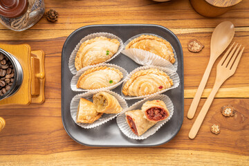 Curry puff on black plate on wooden background, Curry puff pastry on wooden table.