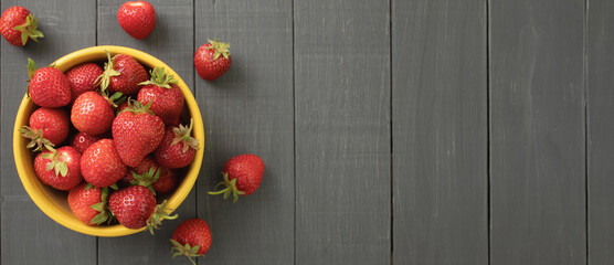 Juicy, ripe strawberry close-up. Panorama, Copy space. Wooden background.