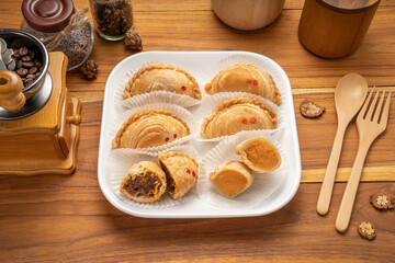Curry puff on white plate on wooden background, Curry puff pastry on wooden table.