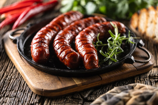 Sausages fried with spices bbq sauce and herbs - Close up