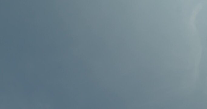 Many donuts falling from the cloudless sky