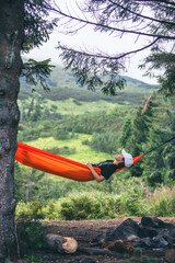 happy woman on hammock mountains on background