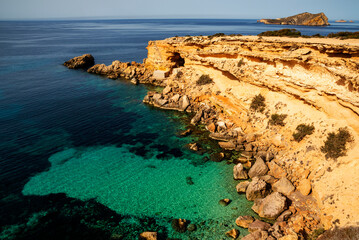 The most beautiful hidden cove with turquoise water and caves near Cala Comte beach, Sant Josep de...