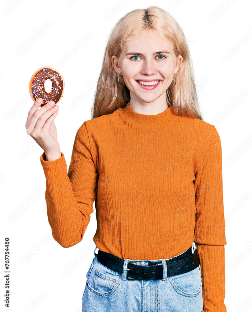 Sticker young caucasian woman holding donut looking positive and happy standing and smiling with a confident