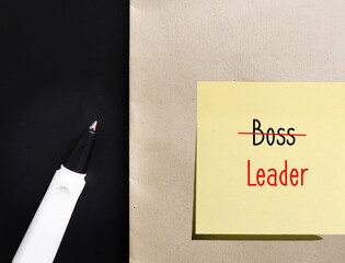 Yellow note with handwritten text BOSS replaced with LEADER, means different mindset of Boss...