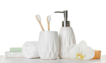 Bath accessories. Different personal care products and flower on table against white background