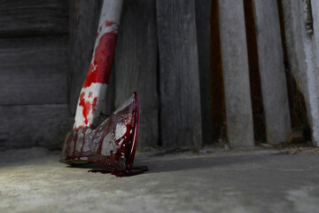 Axe with blood on floor indoors, closeup. Space for text