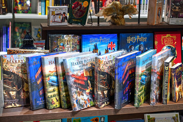 Naklejka premium Minsk, Belarus. Mar 3, 2024. Harry Potter books on display, magical collection of Harry Potter books neatly arranged on store shelf. Novels written by J.K. Rowling and other authors.