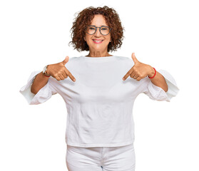 Beautiful middle age mature woman wearing casual clothes and glasses looking confident with smile...