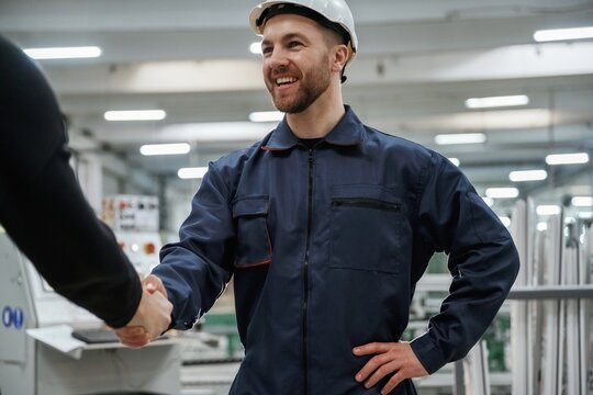 Doing handshake. Man on the factory is making deal with other person