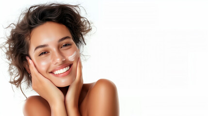 Smiling young woman with glowing, flawless skin gently touching her face: space for your advertisement skin care products