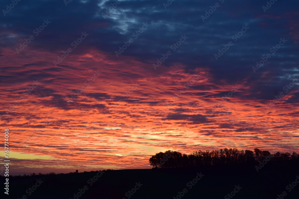 Wall mural burning sunrise sky on a cold monring