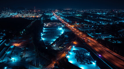 Aerial view night scene, traffic light, city and industrial plant, oil refinery, blue tone,
