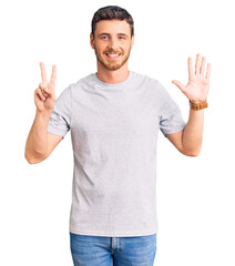 Fototapeta premium Handsome young man with bear wearing casual tshirt showing and pointing up with fingers number seven while smiling confident and happy.
