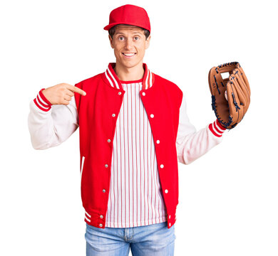Young handsome man wearing baseball uniform holding golve and ball pointing finger to one self smiling happy and proud