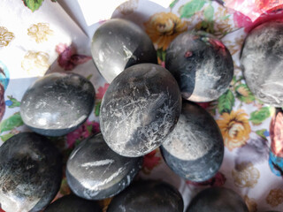 Naturally Dyed Easter Eggs decorated with plants boiled with red cabbage, hibiscus tea creating different colors.