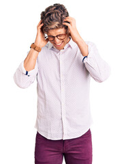 Young handsome man wearing business clothes and glasses suffering from headache desperate and stressed because pain and migraine. hands on head.