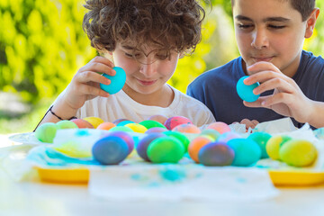 Two Happy Boys Playing with Colorful Easter Eggs - 767786059