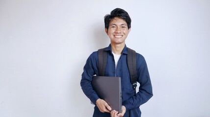 young handsome asian student male happy holding laptop with isolated white background