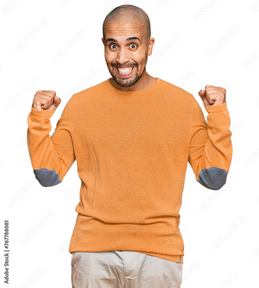 Poster Hispanic adult man wearing casual winter sweater celebrating surprised and amazed for success with arms raised and open eyes. winner concept.