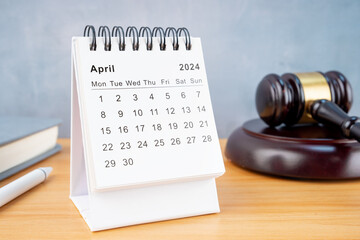 Desk calendar for April 2024 and judge's gavel.